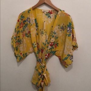 Yellow Anthropologie wrap top with flower print